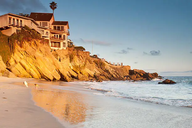 Photo of House on cliffs with playing dogs