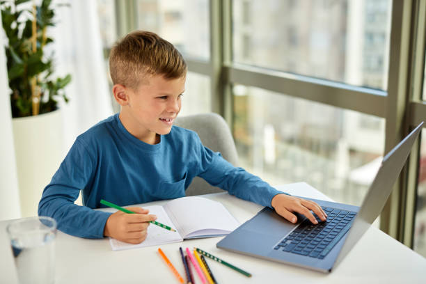 istock School boy watching online education classes on laptop 1353818618
