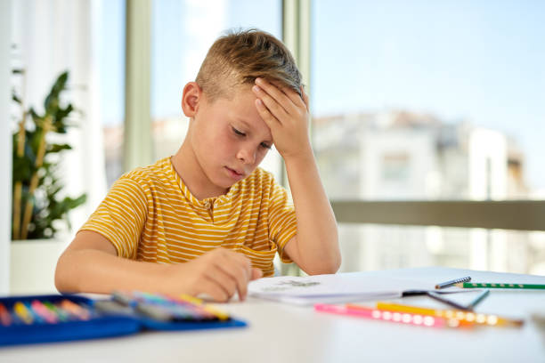 istock Young boy doing his homework. Back to school. Online class from home. 1353818645