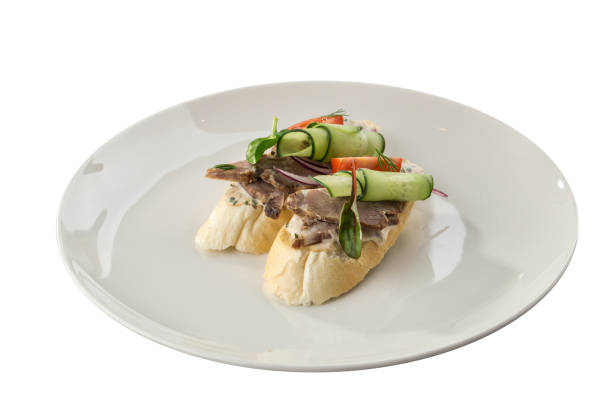 istock open sandwich with boiled pork, fresh cucumber on white plate isolated on white background 1353818722