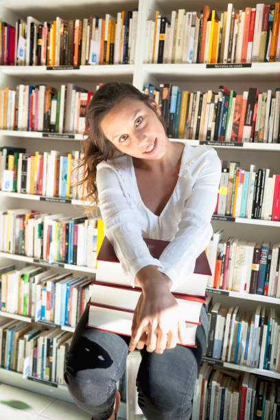 istock Young woman working in the library 1353818741