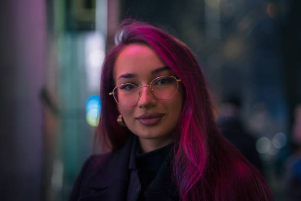 Unconventional woman with pink hair in the night city Portrait of unconventional woman with pink hair in the night city cinematic music photos stock pictures, royalty-free photos & images