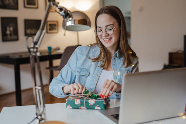istock Young woman is searching for online gift ideas 1353821056