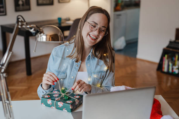 istock Young woman is searching for online gift ideas 1353821164