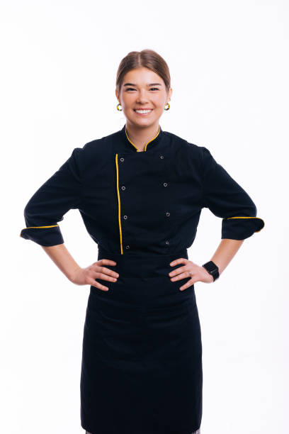 Portrait of beautiful woman, chef posing with hands on waist over white background stock photo