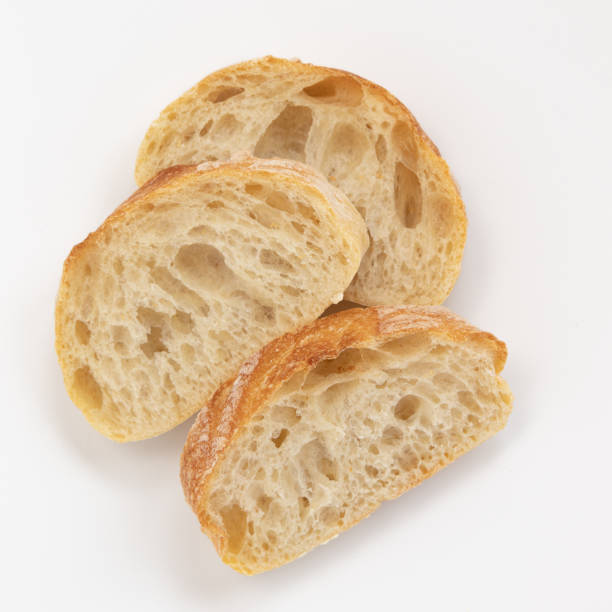 istock baguette pieces isolated on white background, top view 1353822992