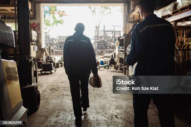 Mental Health And Wellbeing A Pair Of Asian Factory Coworkers Stepping Out For A Rest Stock Photo - Download Image Now
