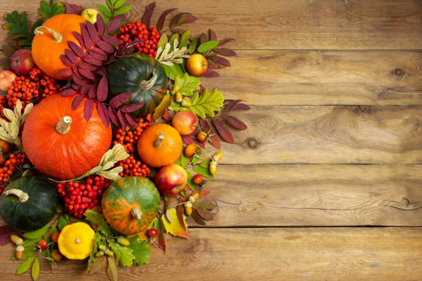 istock Fall pumpkins, rowan berry on the rustic wooden background 1353827072