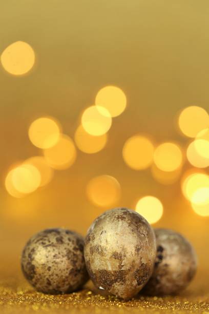 istock Golden Easter eggs in gold glitter on a gold background with bokeh. Easter shiny background 1353827210