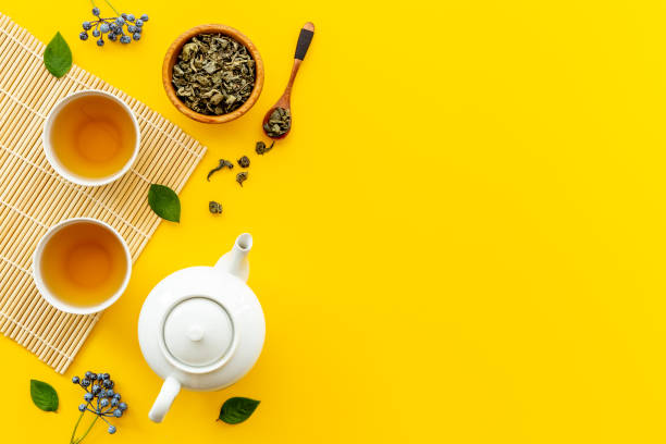 istock Tea drinking with white teapot and black tea in two cups 1353831175