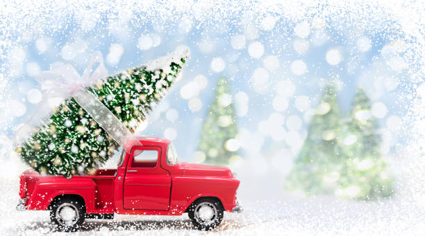 istock Red Car Carrying Christmas Tree with Lights on a Blue Snowy Background 1353834170