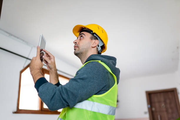 istock Private construction worker standing at customer's front door and checking quality with digital tablet 1353834551