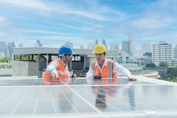 istock Foreman and Worker maintaining solar energy panel. Technicians checking part and equipment for solar energy station. 1353836818