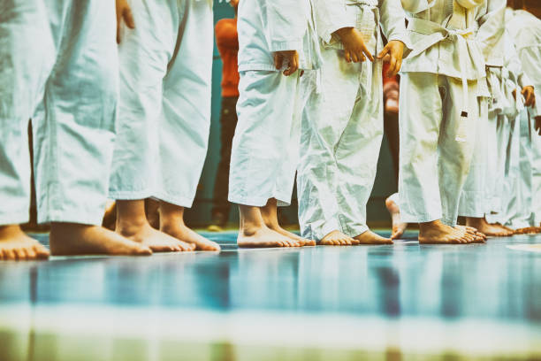 istock Concept karate, martial arts. Construction of students in the hall before training. Kimono, different belts, different levels of training. Close up 1353836899