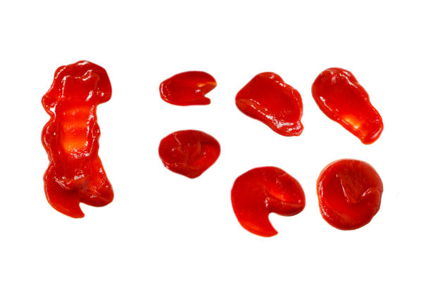 istock Red sauce splashes isolated on white background. Ketchup. 1353836954