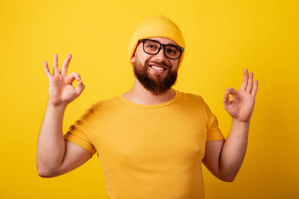 istock bearded man in glasses showing ok gesture 1353837993