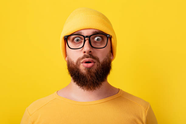 istock surprised man wearing glasses over yellow background 1353838295