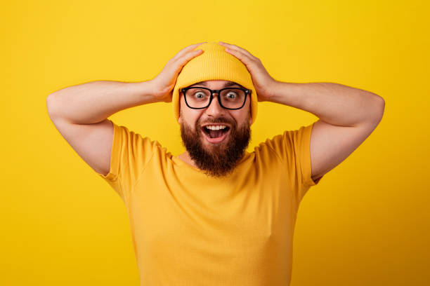 istock surprised man wearing glasses over yellow 1353838473