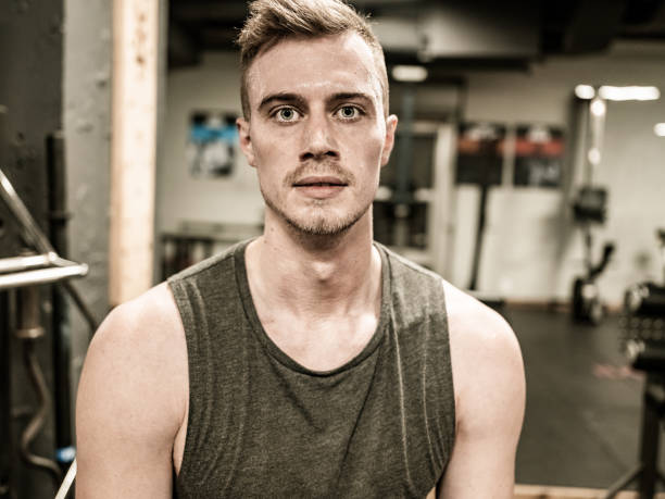 istock Man taking a break while exercising in the Gym 1353839716