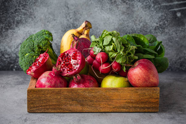 istock Fresh fruit and vegetables in wooden tray 1353843211