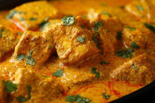 Indian Food Curd Paneer Masala with Butter Nan. Paneer is an Indian Dish of Marinated Paneer Cheese Served in Spiced Gravy