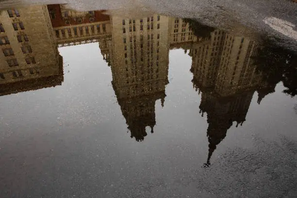 Moscow, Russia september 11. 2021 Reflection of the main building of Moscow State University in a puddle, autumn architecture after rain