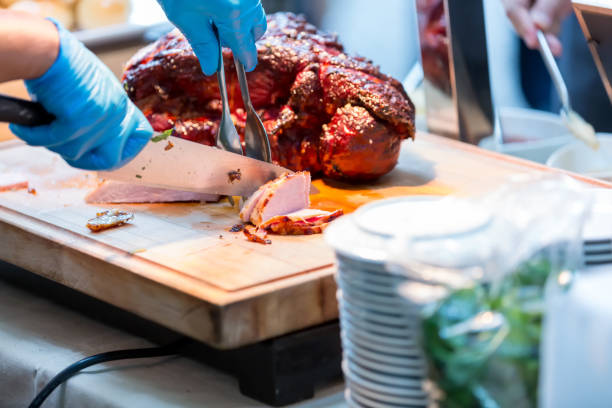 istock Roast pork neck. Roasted shoulder of pork on a cutting board. 1353847548