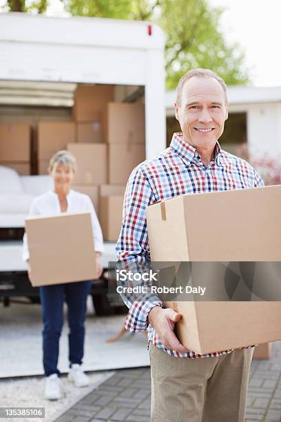 Couple Carrying Boxes From Moving Van Stock Photo - Download Image Now - 60-64 Years, Achievement, Active Seniors