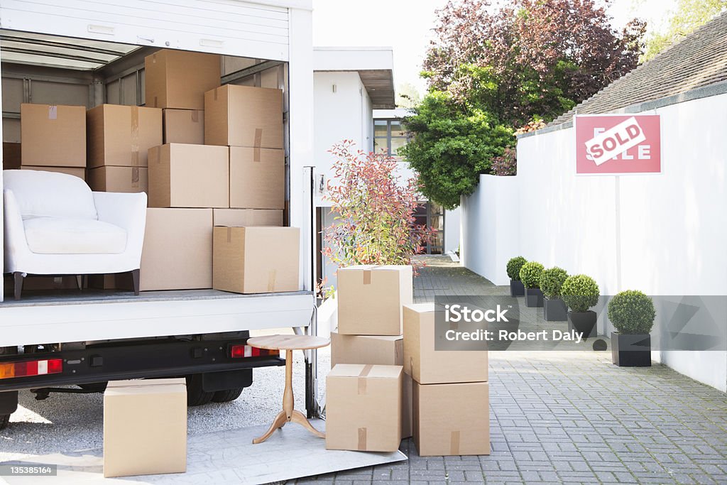 Boxes on ground near moving van  Moving Van Stock Photo