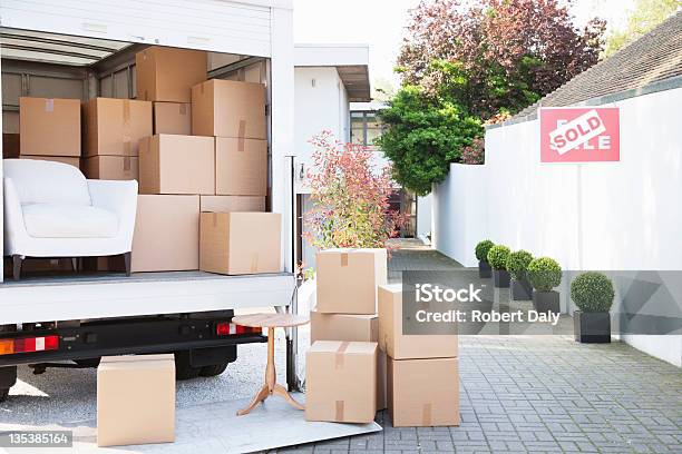Boxes On Ground Near Moving Van Stock Photo - Download Image Now - Moving Van, Relocation, Box - Container