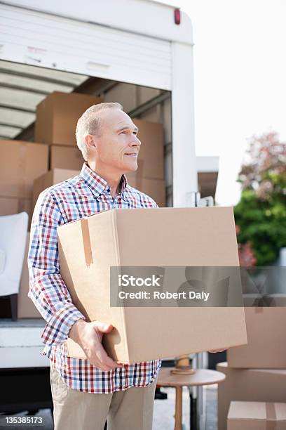 Man Unloading Box From Moving Van Stock Photo - Download Image Now - Moving Van, Adult, Adults Only