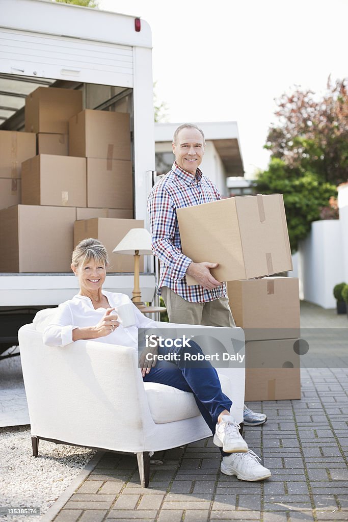 Couple unloading moving van  Armchair Stock Photo