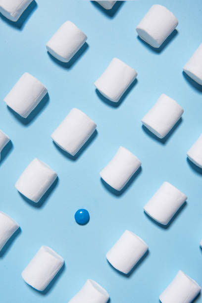 istock Sweeties marshmallows over blue table background. 1353853916