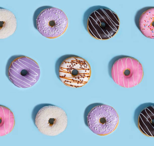 istock Colorful sweeties donuts over blue table background. 1353855684