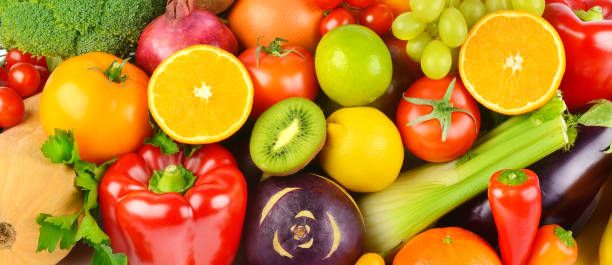 istock Bright background from different vegetables and fruits. Wide photo. 1353856643