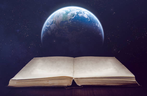 istock Ancient opened book and Earth globe with stars on background. Elements of this image furnished by NASA 1353863643