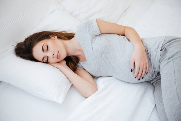 istock Side view of sleeping pregnant woman 1353867085