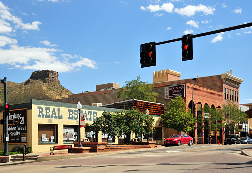 Golden, Jefferson County, Colorado: traffic lights in Washington Avenue, lined with old west facade, heart of the historic district - Castle Rock butte in the background.