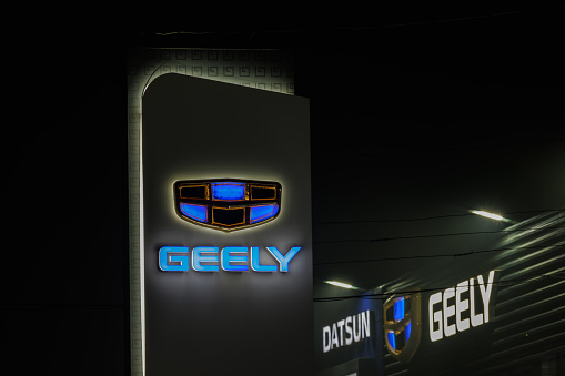 Geely logo on car dealership pillar building at foggy night - Geely is one of the largest Chinese automobile manufacturer - Tula, Russia, 02 11 2021