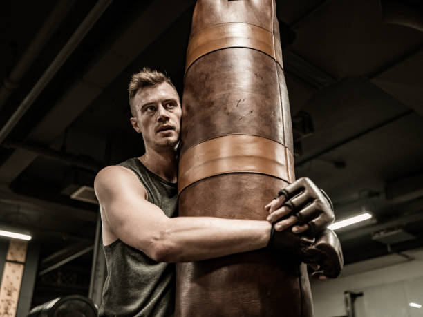 istock Man exercising with beanbag in the Gym 1353873719