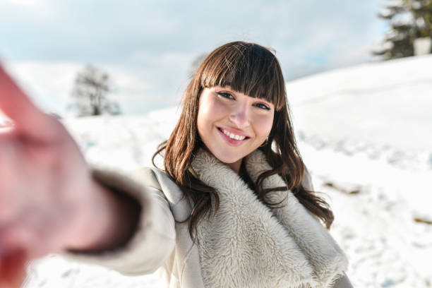 istock Smiling Snow Selfie By Beautiful Female 1353874211