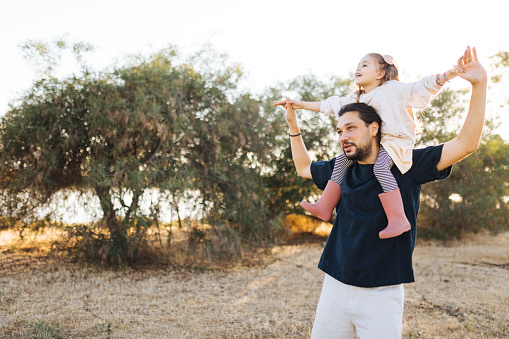 Concept of father's day! happy family dad and child daughter back in nature