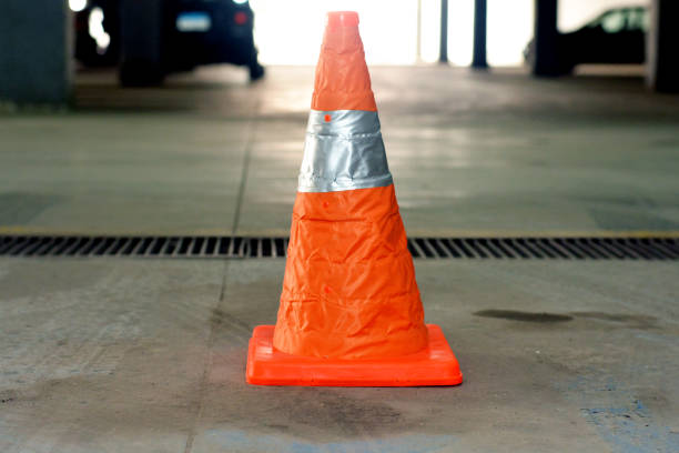 istock traffic pylon road cone in a garage , Cone of security that is designed especially to indicate points or areas of possible risks to large distance 1353876816