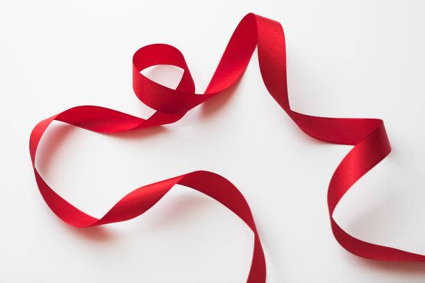 istock loops of red  ribbon on gray text place - Image 1353879060