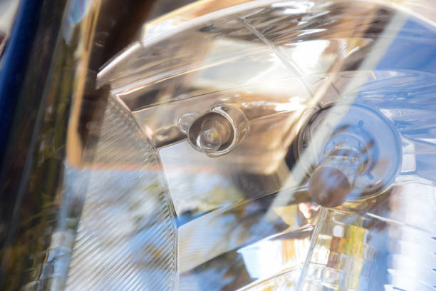 Car headlight of a modern car close up with bulbs seen through glass