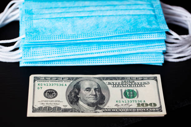 istock surgical masks and 100 dollar 1353882511