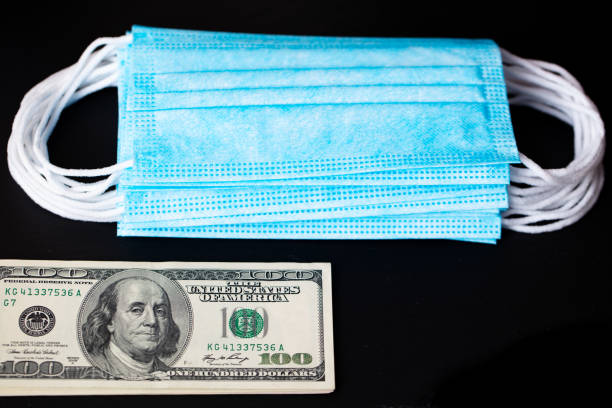 istock surgical masks and 100 dollar 1353882515