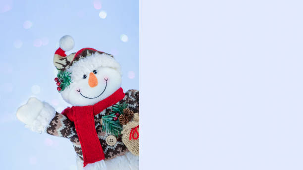 istock Happy snowman behind blank card 1353882802