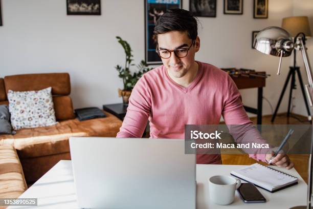 Young Man Is Working On Laptop Stock Photo - Download Image Now - Student, Laptop, Studying