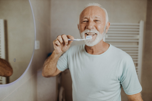 Senior man brushing his teeth